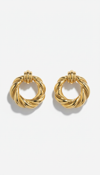 Gilded gold statement hoop earrings, perfectly centered horizontally and vertically with equal negative space above and...